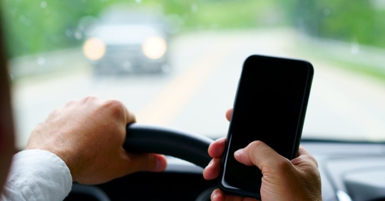 person using phone while driving