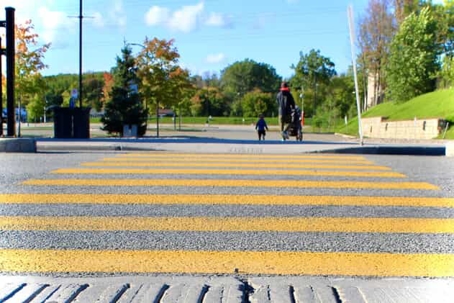 Yellow crosswalk with a family on the other side